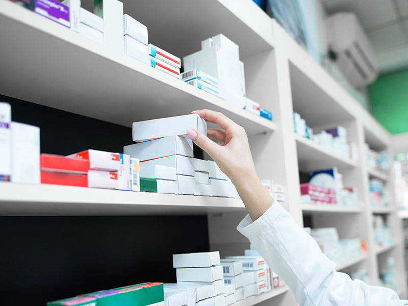 closeup-view-of-pharmacist-hand-taking-medicine-box-from-the-shelf-in-drug-store